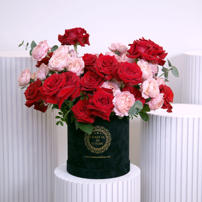 pink and red roses in black box