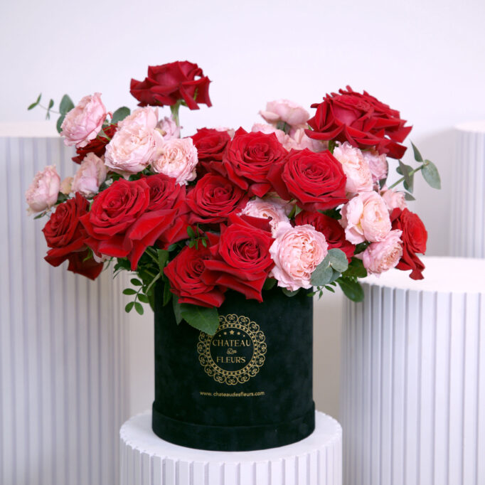 pink and red roses in black box