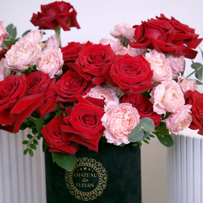 pink and red roses in black box