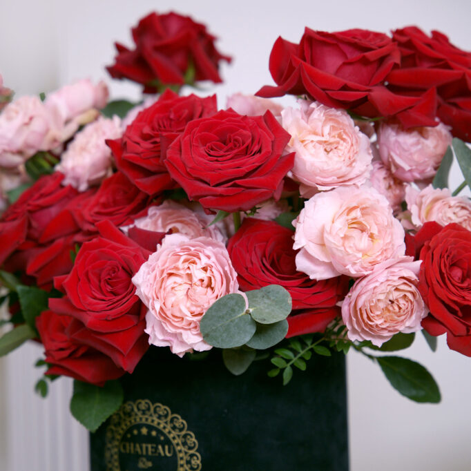 pink and red roses in black box